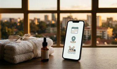 A smartphone showing a spa booking app beside white towels and a small oil bottle.